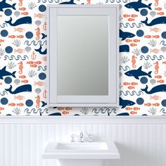 a white sink sitting under a bathroom mirror next to a wall mounted faucet