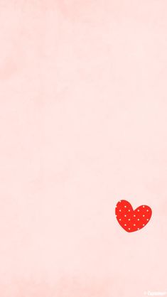 a red polka dot heart on a pink background