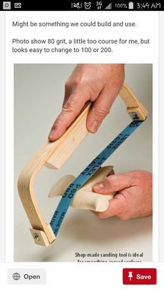 a person holding a wooden ruler and measuring it with one hand on top of the other