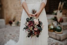 a woman in a white dress holding a bouquet