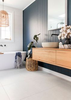 a bathroom with blue walls and white floors