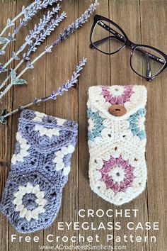 two crocheted eyeglass cases sitting on top of a wooden table next to lavender flowers