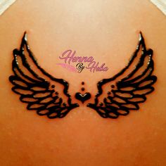 the back of a woman's stomach with black wings on it