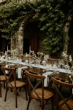 an outdoor dining area with tables and chairs set up for a formal dinner or party