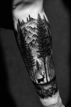 a man's arm with a forest scene and deer