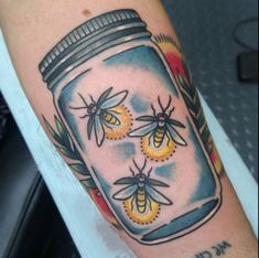 a jar with some bees in it on the arm