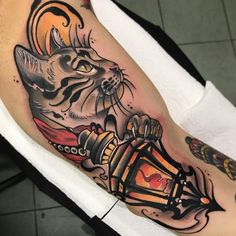 a cat with a lantern tattoo on its leg