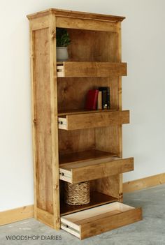 a wooden bookcase with drawers in the corner