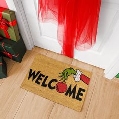 a welcome mat on the floor next to presents