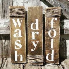 three wooden blocks with words on them sitting next to an old barn door and window