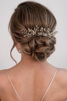 the back of a woman's head wearing a bridal hair piece