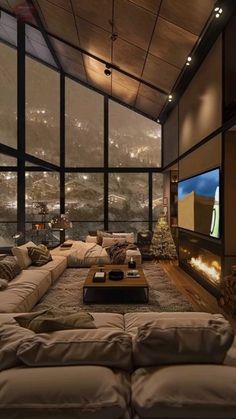 a large living room with couches and a flat screen tv on the wall above it