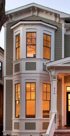 a large house with many windows and steps leading up to it