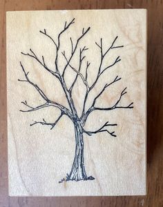 a wooden block with a tree drawn on it