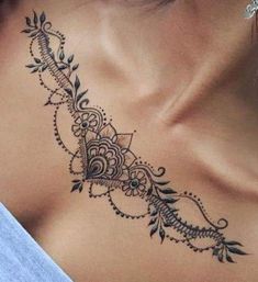 the back of a woman's neck with an intricate design on her left side