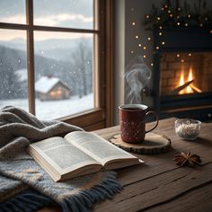 a cup of coffee and an open book on a table in front of a fireplace