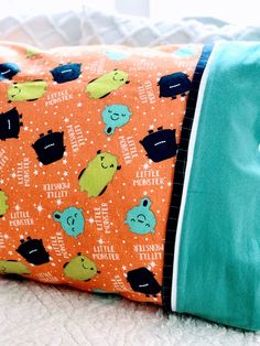 an orange and blue pillow with bears on it