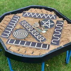 a table made out of sand with different designs on it