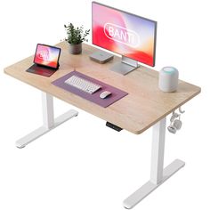 a computer desk with a monitor, keyboard and mouse on it next to a laptop