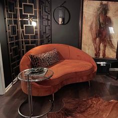 a living room with an animal print rug and couches in the middle of it