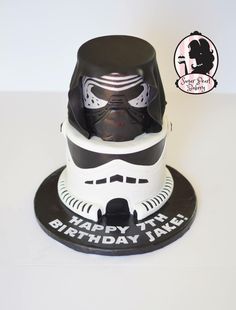 a star wars themed birthday cake with a helmet on top