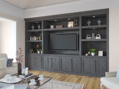 a living room filled with furniture and a flat screen tv on top of a wooden entertainment center