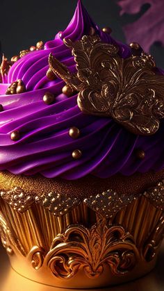 a cupcake with purple frosting and gold decorations