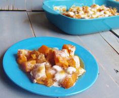 a blue plate topped with food next to a bowl filled with pudding and marshmallows