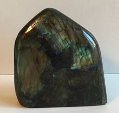 a large green rock sitting on top of a white table