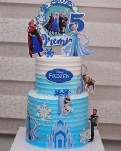 a frozen princess birthday cake with figures on it