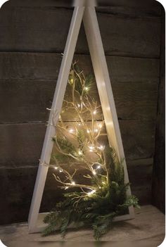 a triangle shaped christmas tree with lights on it