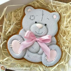 a decorated cookie in the shape of a teddy bear