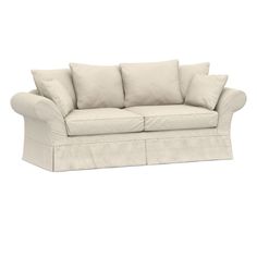 a white couch with four pillows on the back and one arm folded over it's head