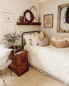 a bedroom with a bed, dresser and other items on the shelves above it is decorated with wreaths