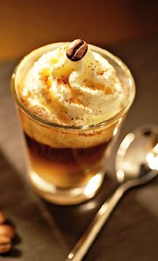 an advertisement for irish coffee with whipped cream in a cup and spoon on the side