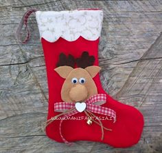 a red christmas stocking with a reindeer on it