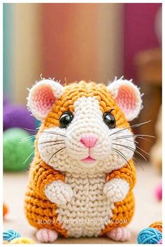 a small crocheted hamster sitting on top of a table