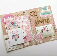 a pink scrapbook with lots of different things on the page and some writing in it