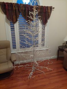 a white tree in front of a window