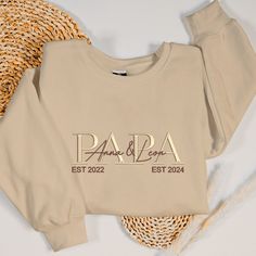 Celebrate Father's Day with our Custom Embroidered Father's Day Sweatshirt, personalized with the names of his two children. This heartfelt gift is the perfect way to show your appreciation and love for the best dad ever. Design: Our custom sweatshirt features beautifully embroidered names of his children, making it a unique and sentimental piece. The intricate embroidery adds a personal touch that highlights the special bond between a father and his kids. Material: Crafted from high-quality fab Personalized Long Sleeve Tops With Custom Text, Embroidered Names, Gift For New Dad, Year Sweatshirt, Super Papa, Father Presents, Best Dad Gifts, Super Dad, Best Dad Ever