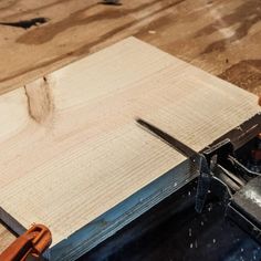 a piece of wood being cut with a planer