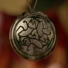 a silver locke with an image of two cats on it's side hanging from a chain