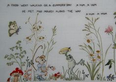 a cross stitch pattern with an image of a mouse and other animals in the grass