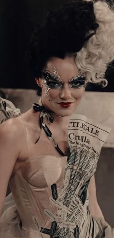 a woman with black and white makeup holding a newspaper