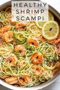 a pan filled with shrimp and zucchini pasta