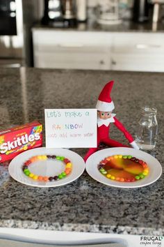 an elf is sitting on the counter next to some candy