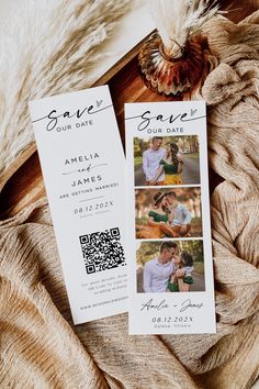 two wedding save the dates cards on top of a furnishing blanket with a feather