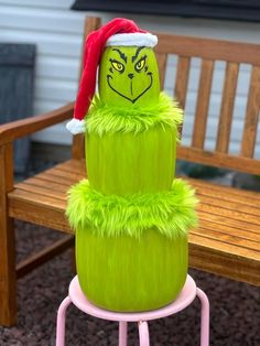 a green cake sitting on top of a wooden bench