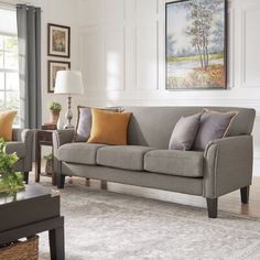 a living room scene with focus on the couch and chair, which is decorated in neutral colors