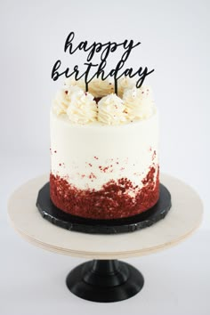 a birthday cake with white and red frosting